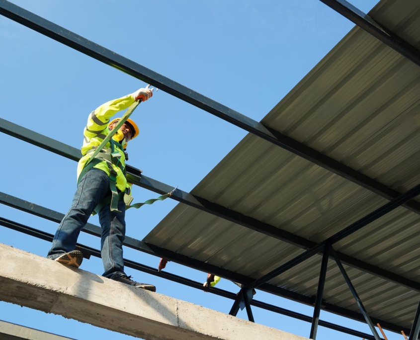 Worker Standing On Metal Roof