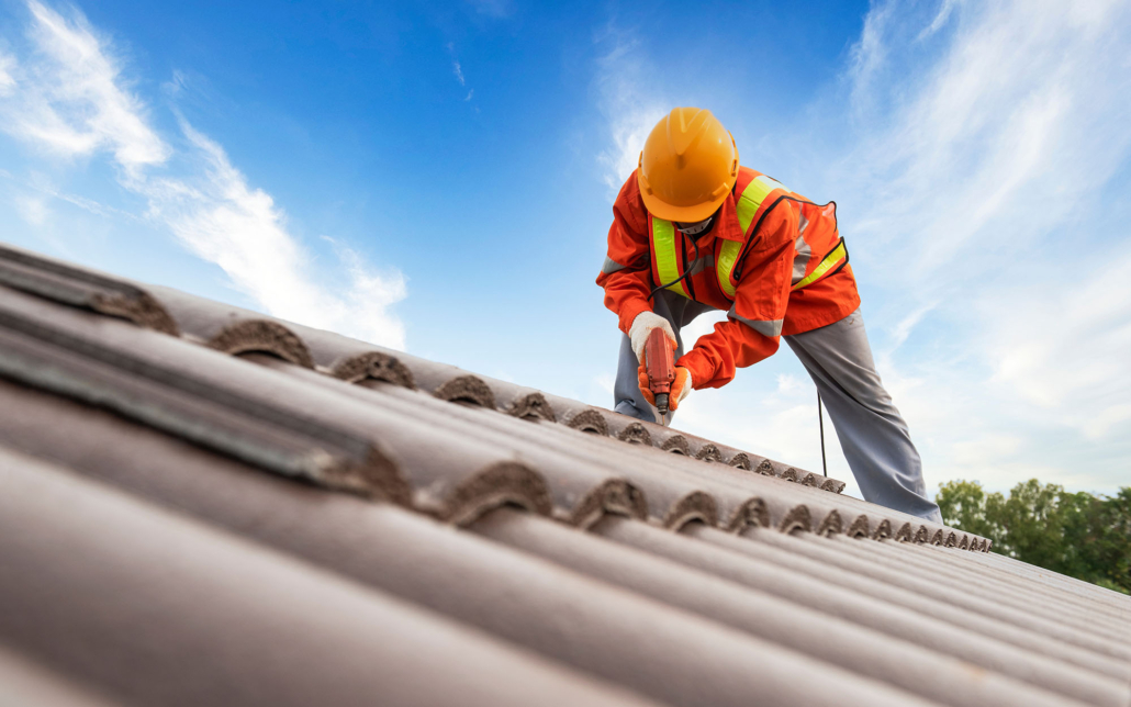 Worker Drilling In New Tile Roof