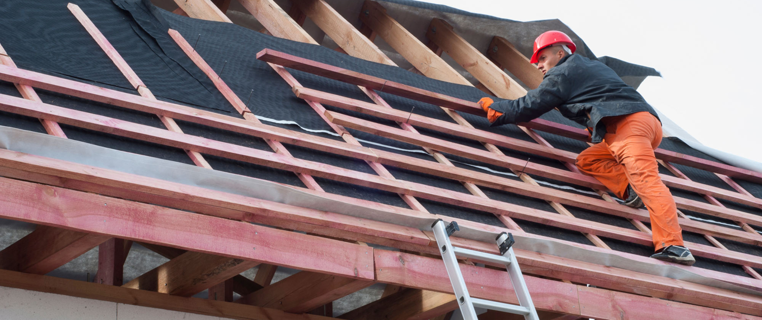 Worker On Ladder Repairing Roof